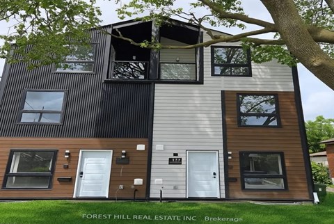 A modern two-story house with a balcony on the second floor.