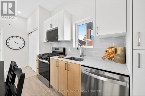 A kitchen with a stove top oven and microwave.