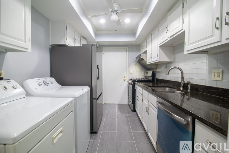 A kitchen with a white oven and black countertops.