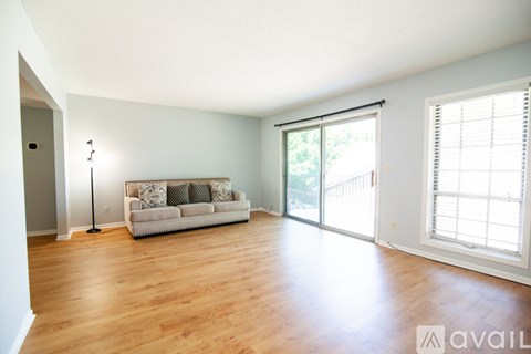 A living room with a couch and a floor lamp.