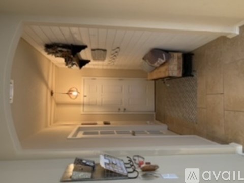 A kitchen with a white counter top and a white fridge.