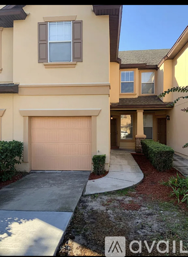 A house with a garage door and a driveway.