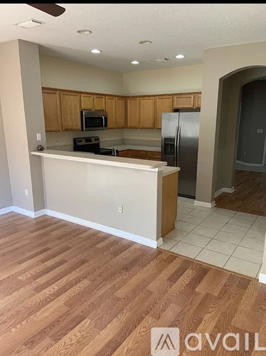 A kitchen with wooden cabinets and a white counter.