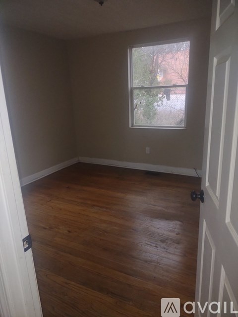 A room with wooden floors and a window.