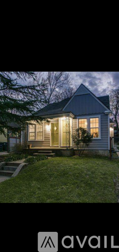 A house with a front yard and a porch.