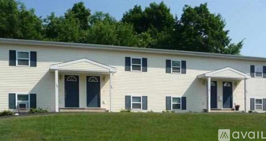 A white house with a black door and windows.