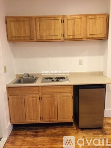 A kitchen with wooden cabinets and a white countertop.