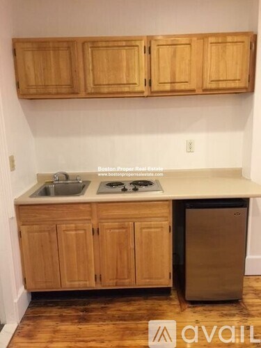 A kitchen with wooden cabinets and a white countertop.