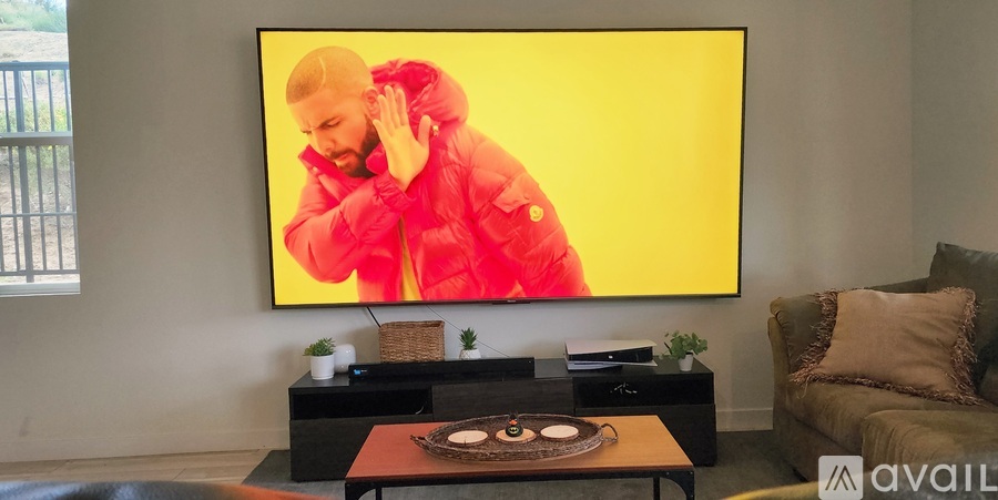 A person in a red jacket is dancing on a yellow screen.