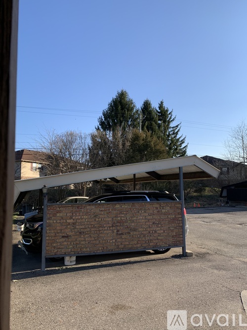 A parking area with cars and a building in the background.
