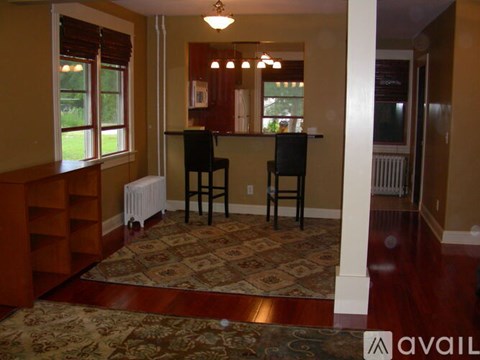 A room with a brown carpet and a brown wooden floor.