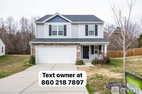 A house with a sign that says "Text owner at 860 218 7897".