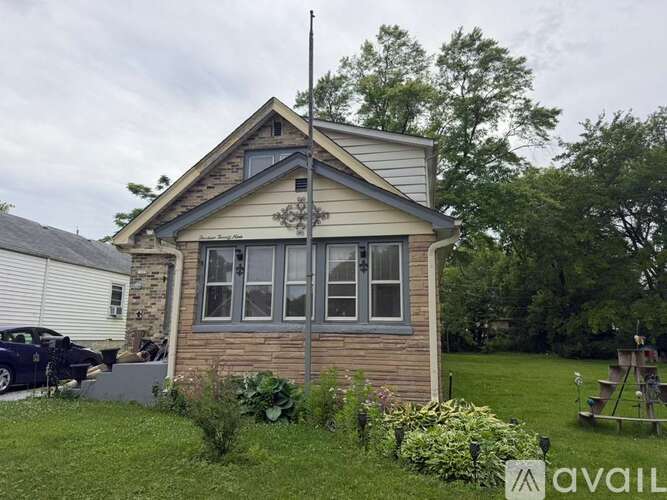 A house with a car parked in front of it.