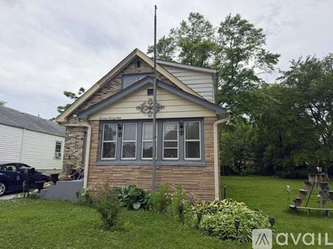 A house with a car parked in front of it.