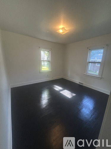 A room with wooden floors and a ceiling with wooden beams.