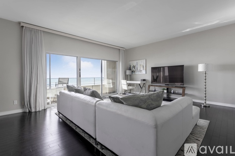 A modern living room with a white sofa and a television.