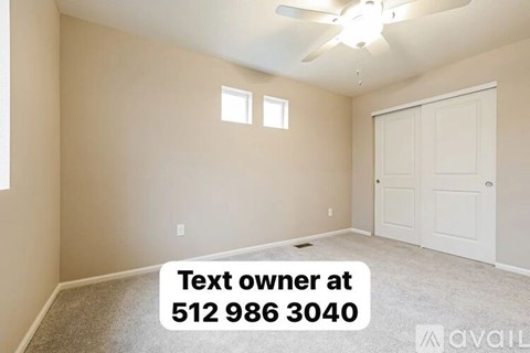 A room with a ceiling fan and a text box with a phone number.