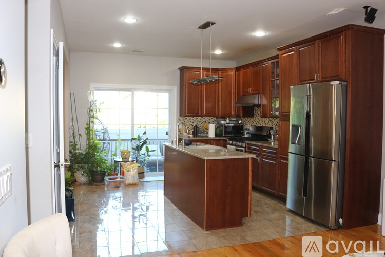 A kitchen with wooden cabinets and a refrigerator.