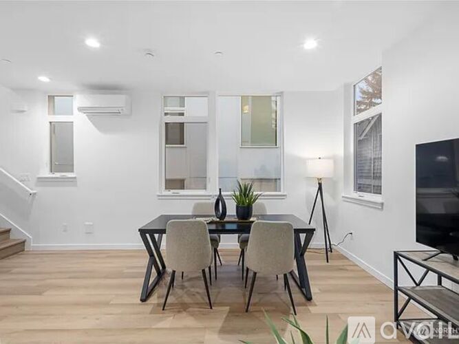 A modern dining room with a glass table and chairs.