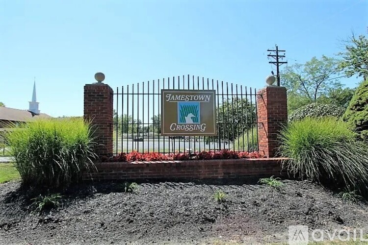 A sign that says Tamestown Crossing is on a gate.