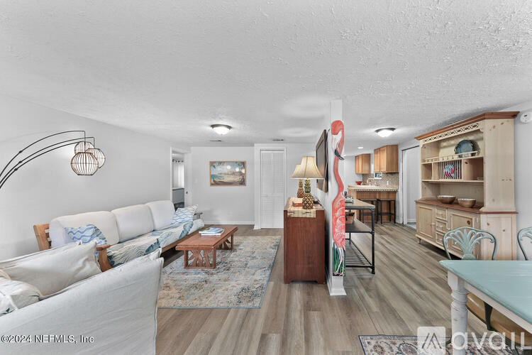A living room with a white couch and a wooden coffee table.