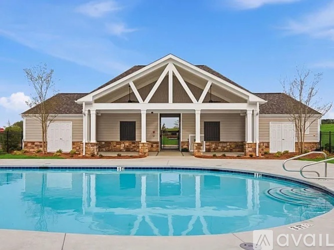 A house with a pool in front of it.
