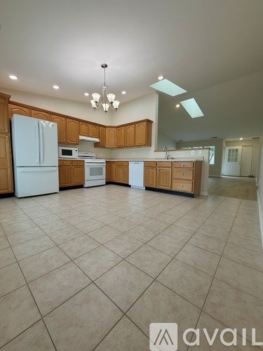 A kitchen with wooden cabinets and a white refrigerator.