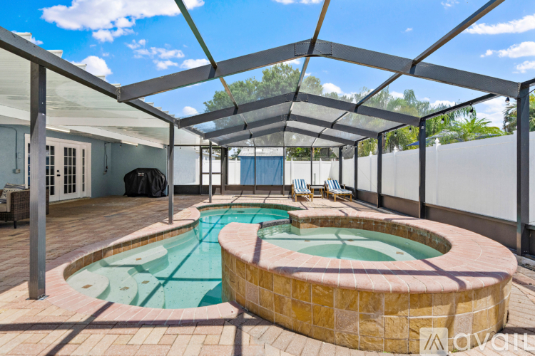 A pool with a glass enclosure and a tiled floor.
