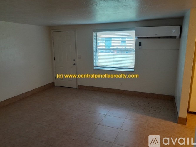A room with a door, window, and a tiled floor.