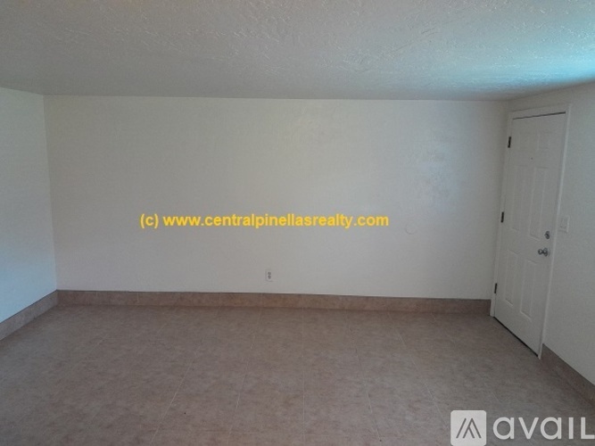 A room with a door and a wall with a website address on it.
