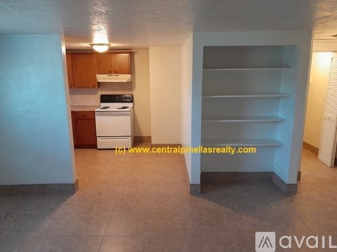 A kitchen with a white stove and wooden cabinets.