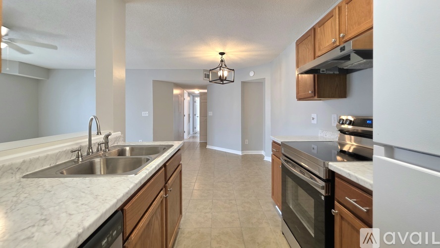 A kitchen with wooden cabinets and a marble countertop.