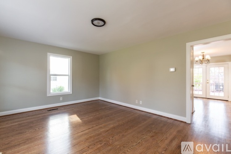 A room with wooden flooring and a window.