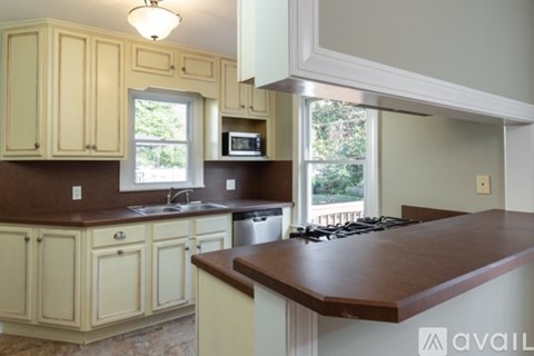 A kitchen with wooden cabinets and a brown countertop.