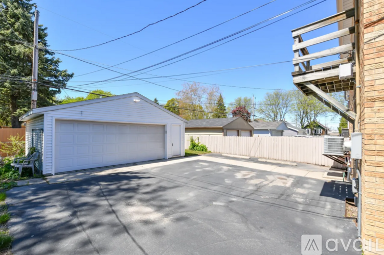 A detached house with a white garage door.