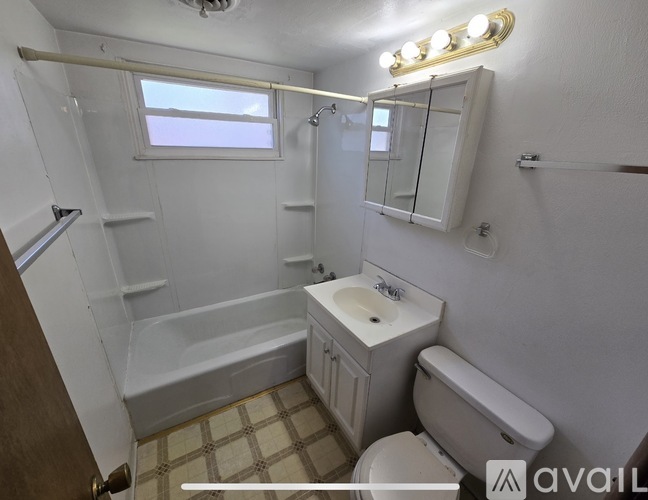 A bathroom with a white sink, toilet, and bathtub.