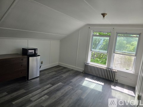 A room with a window and a radiator on the wall.