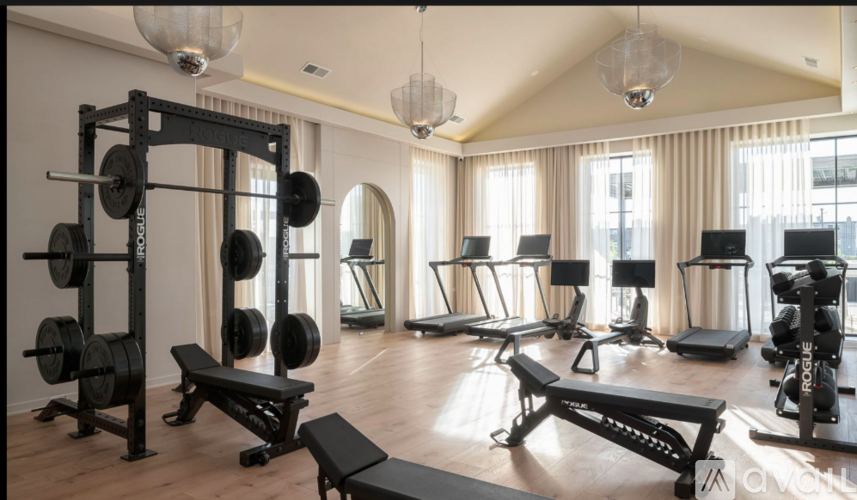A well-equipped home gym with various exercise machines and weights.