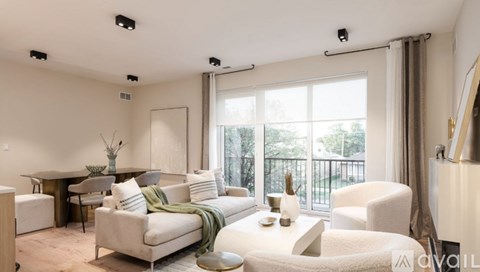 A living room with a white sofa and a glass table.