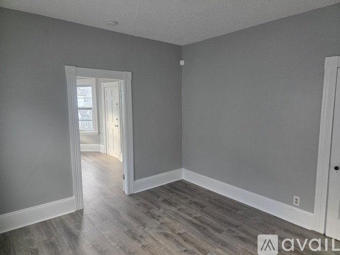 A room with a doorway leading to another room.