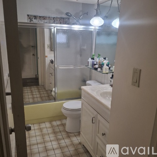 A bathroom with a toilet, sink, and shower.
