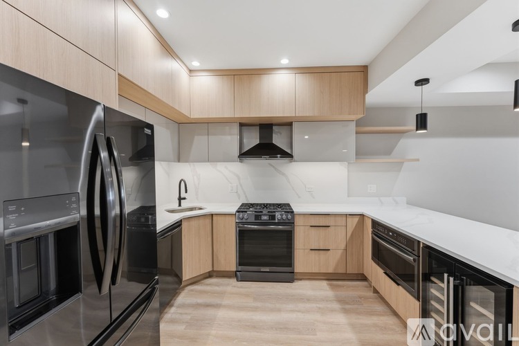 A modern kitchen with wooden cabinets and stainless steel appliances.