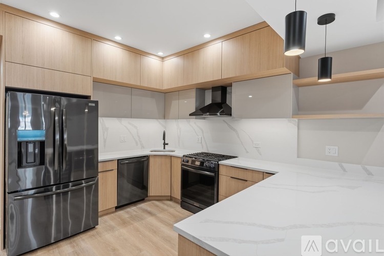 A modern kitchen with wooden cabinets and stainless steel appliances.