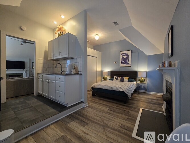 A bedroom with a bed, a cabinet, and a mirror.