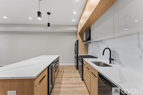 A modern kitchen with wooden cabinets and a white countertop.