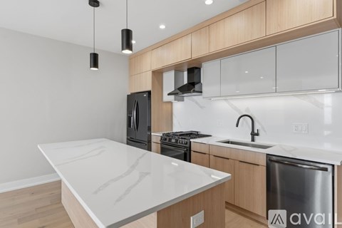 A kitchen with a white countertop and wooden cabinets.