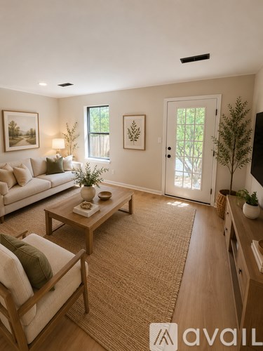A living room with a couch, coffee table, and pictures on the wall.