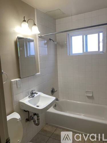 A bathroom with a white sink and bathtub.