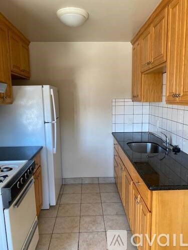 A kitchen with wooden cabinets and a white refrigerator.