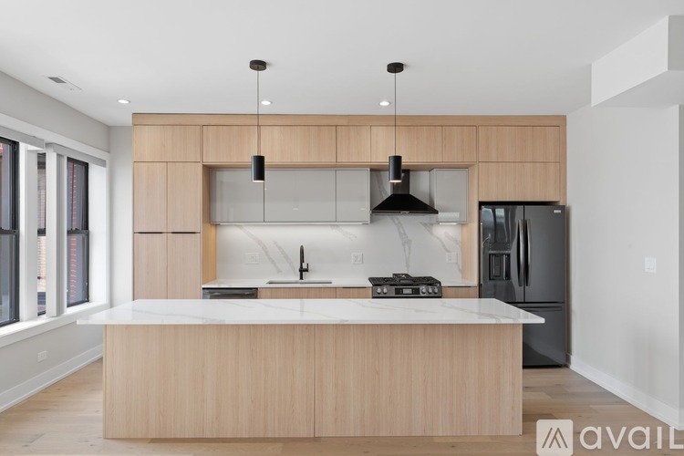 A modern kitchen with a wooden island and stainless steel appliances.